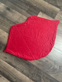 a red blanket on a wooden floor