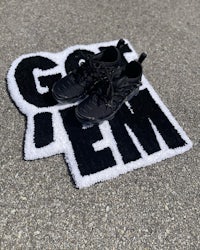 a black and white rug with the word go em on it