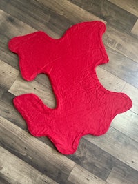 a red jigsaw puzzle on a wooden floor