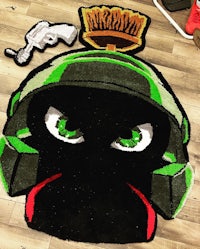 a green and black rug with a green and black helmet on it